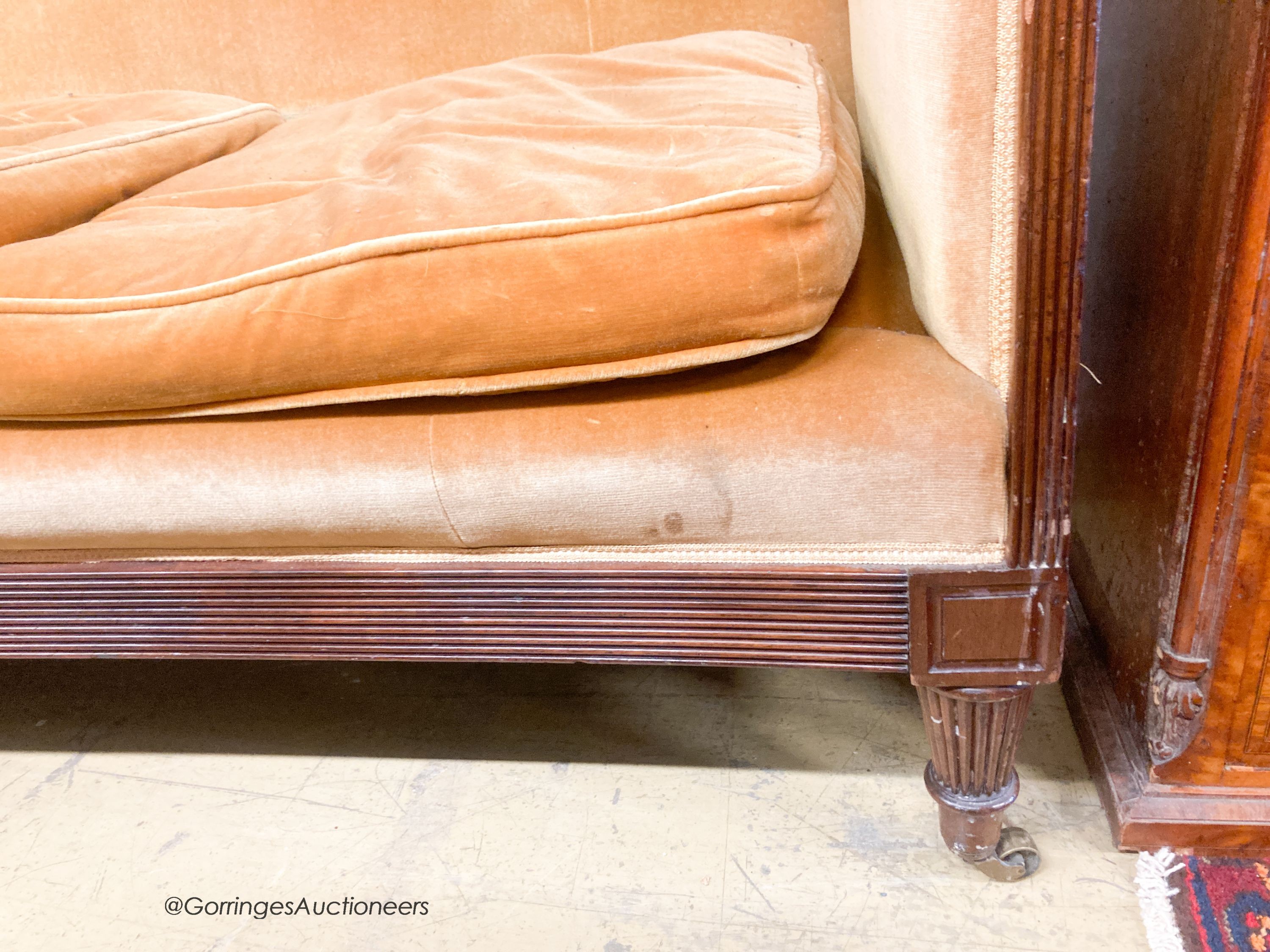 A Regency settee, with a reeded mahogany frame upholstered in gold dralon, length 195cm, depth 74cm, height 95cm